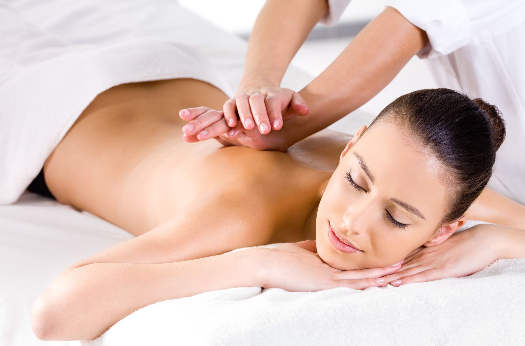 therapist giving back massage